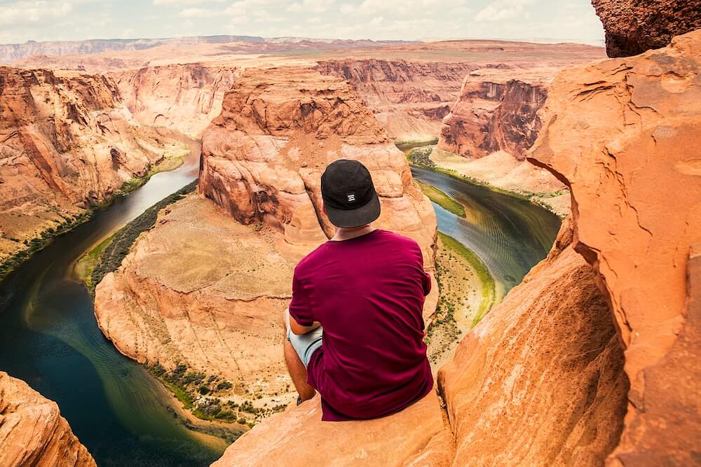 A male solo traveller looking over the Grand Canyon, USA.