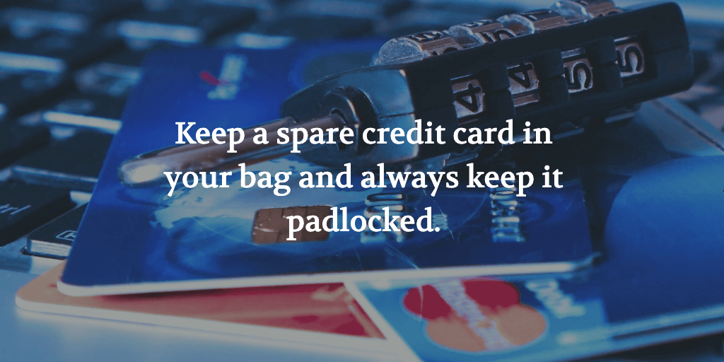 The text reads, 'Keep a spare credit card in your bag and always keep it padlocked when travelling alone.' A padlock on top of some credit cards.