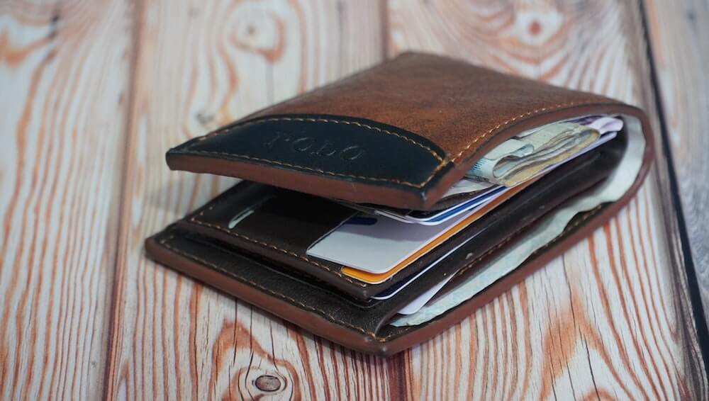 A bulky wallet full of cards, cash and documents.