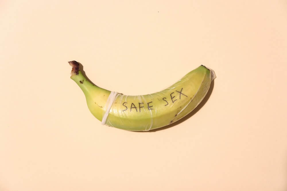 A banana with a condom on it and the words 'safe sex'.