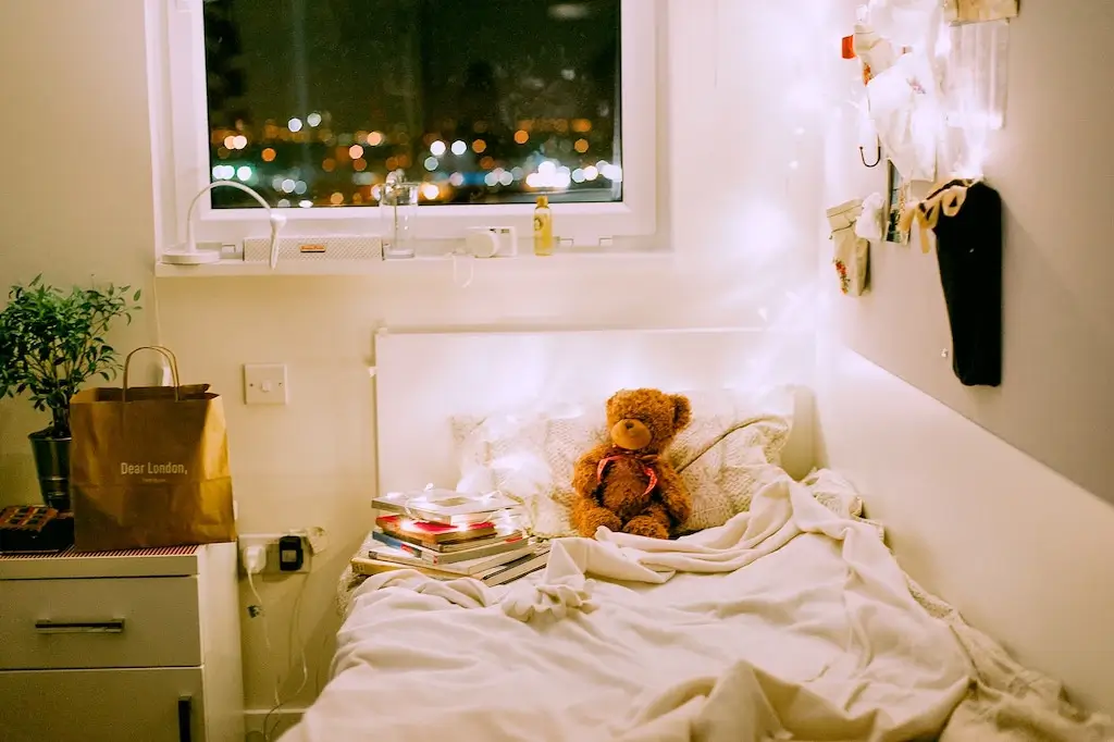 Cosy female bedroom with fairylights and teddy