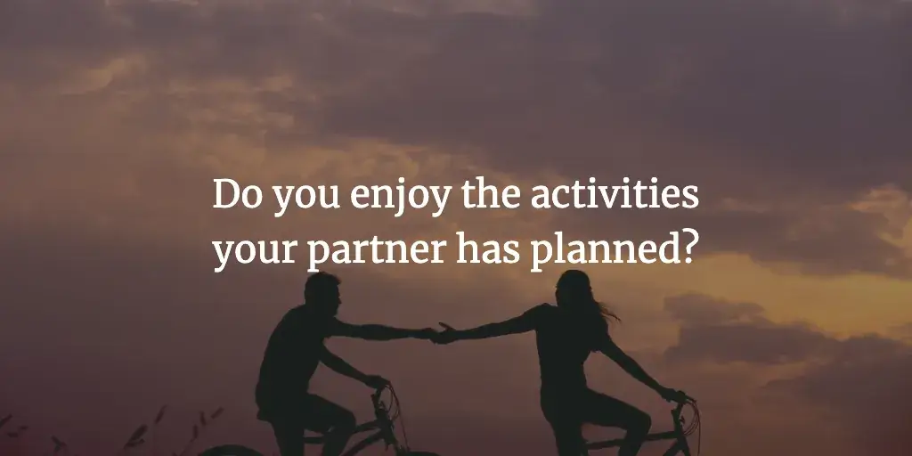 A couple riding bikes together and holding hands. The text reads, 'Do you enjoy the activities your partner has planned?'