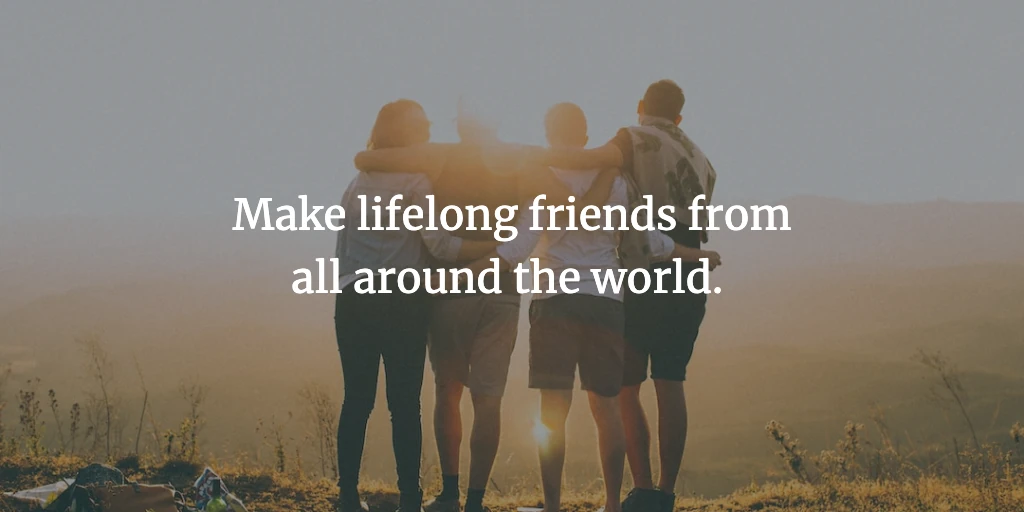 Four travel buddies link arms around one another whilst watching the sunset in the hills. The text reads, 'Make lifelong friends from around the world.'