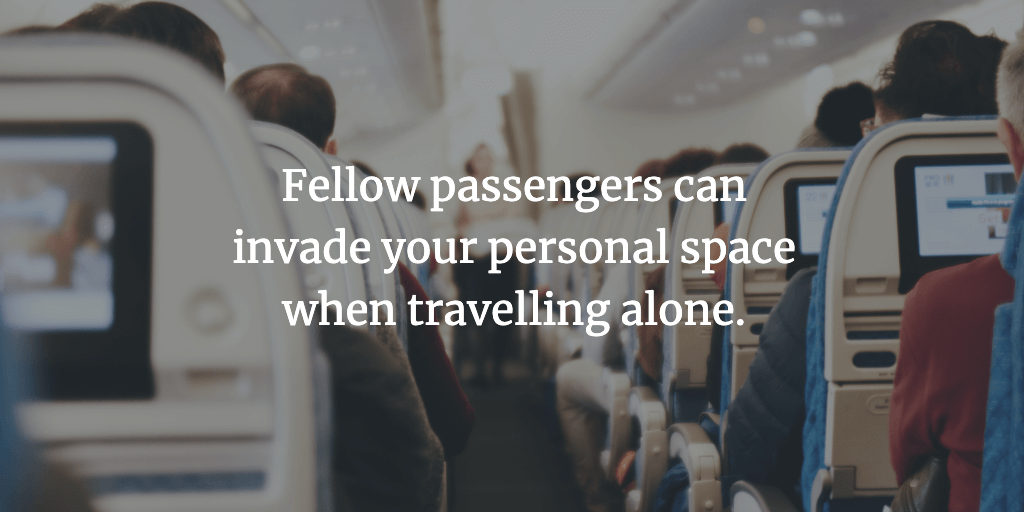 The aisle of a plane full of passengers. The text reads, 'Fellow passengers can invade your personal space when travelling alone.'