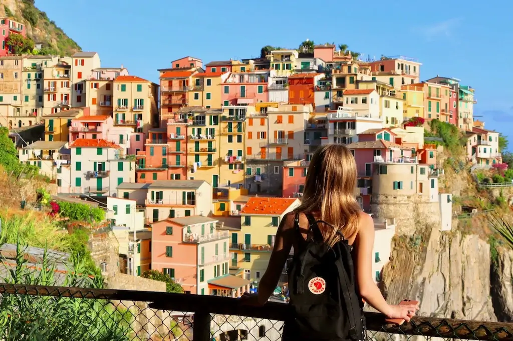 Solo female backpacker overlooking the Amalfi Coast, Italy.