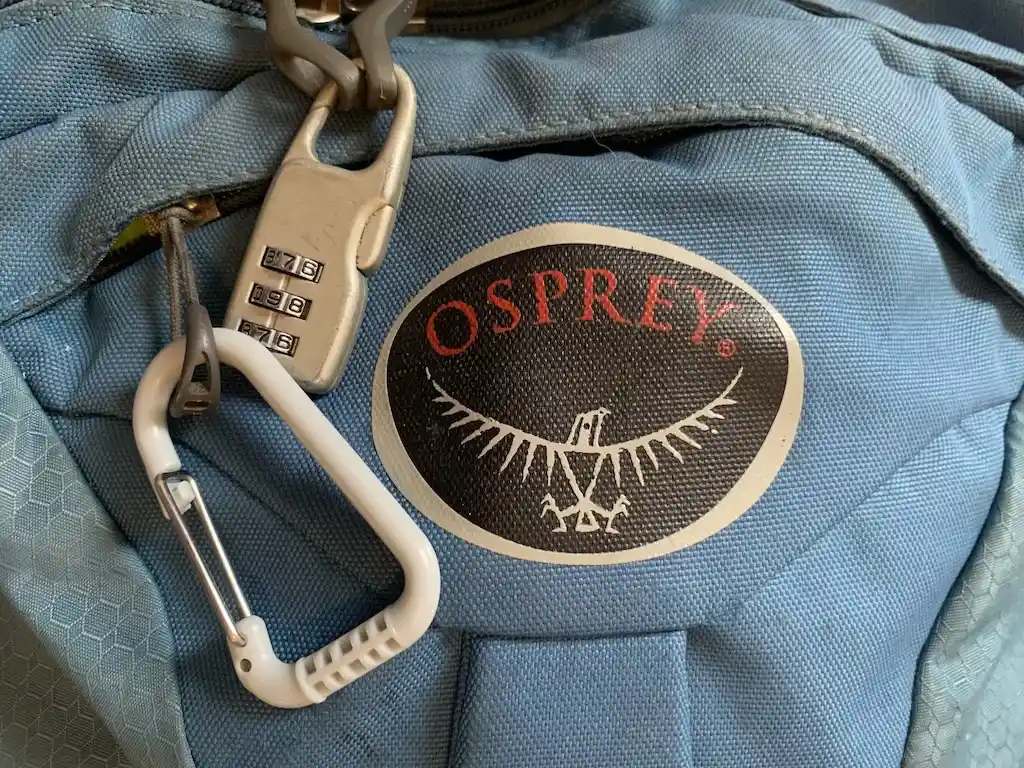 A numeric padlock on an Osprey travel backpack.