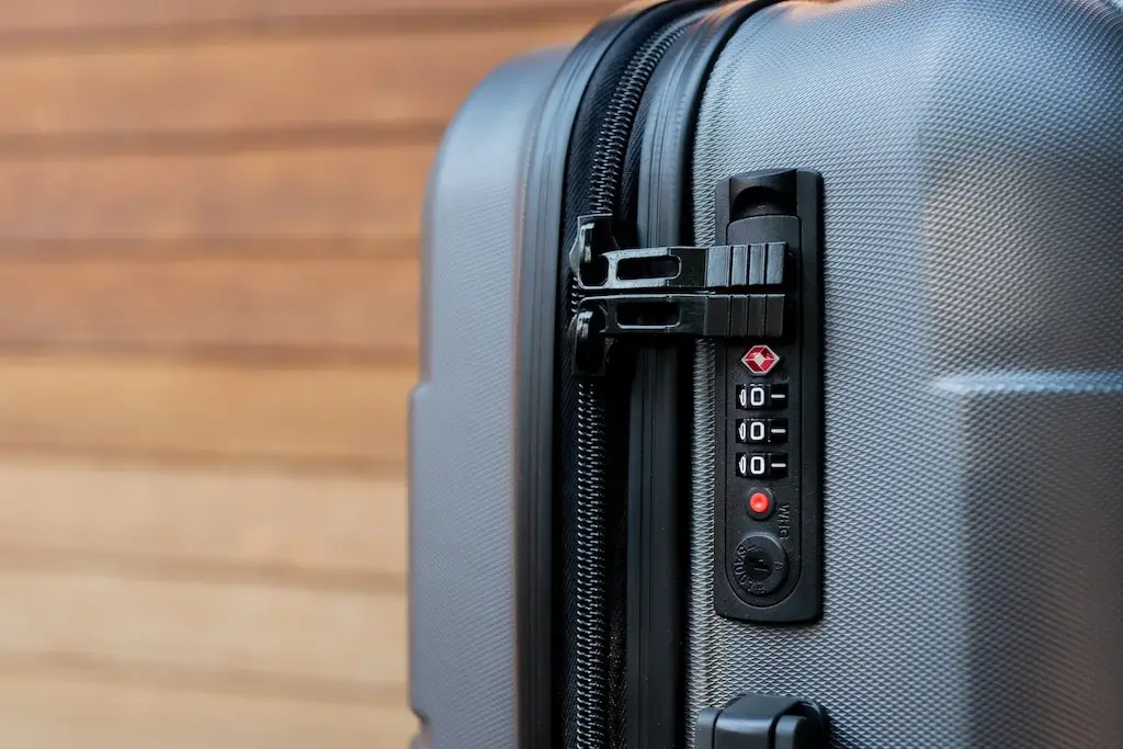 Zipper and TSA padlock on a suitcase.