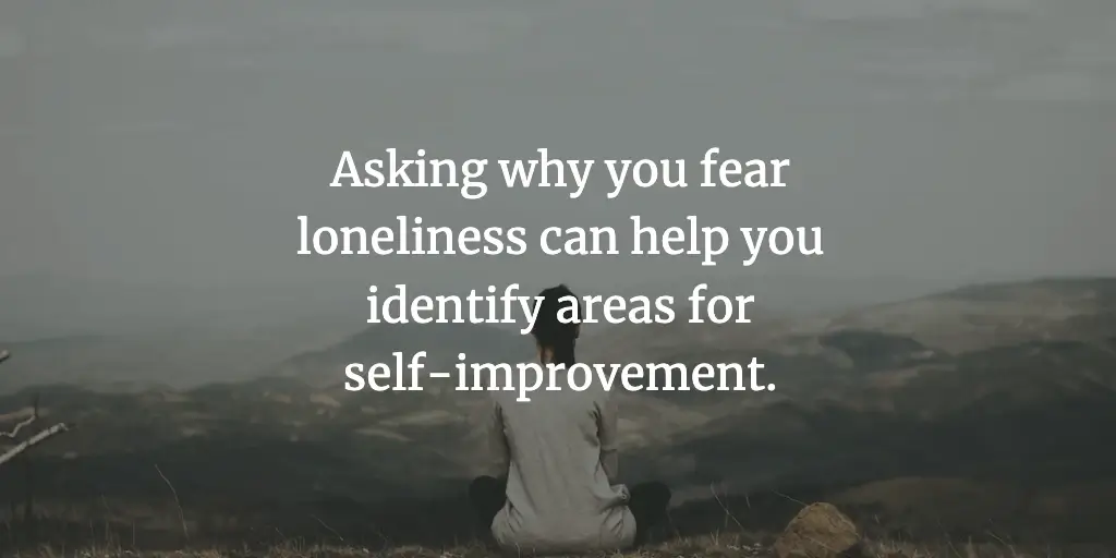 A woman meditates on a hill top. The text reads, 'Asking why you fear loneliness can help you identify areas for self-improvement.'