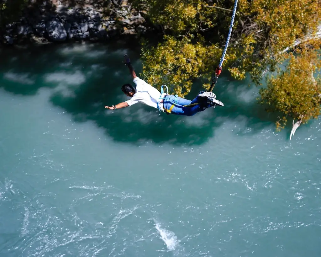 A bungee jumper plunging into the river below.