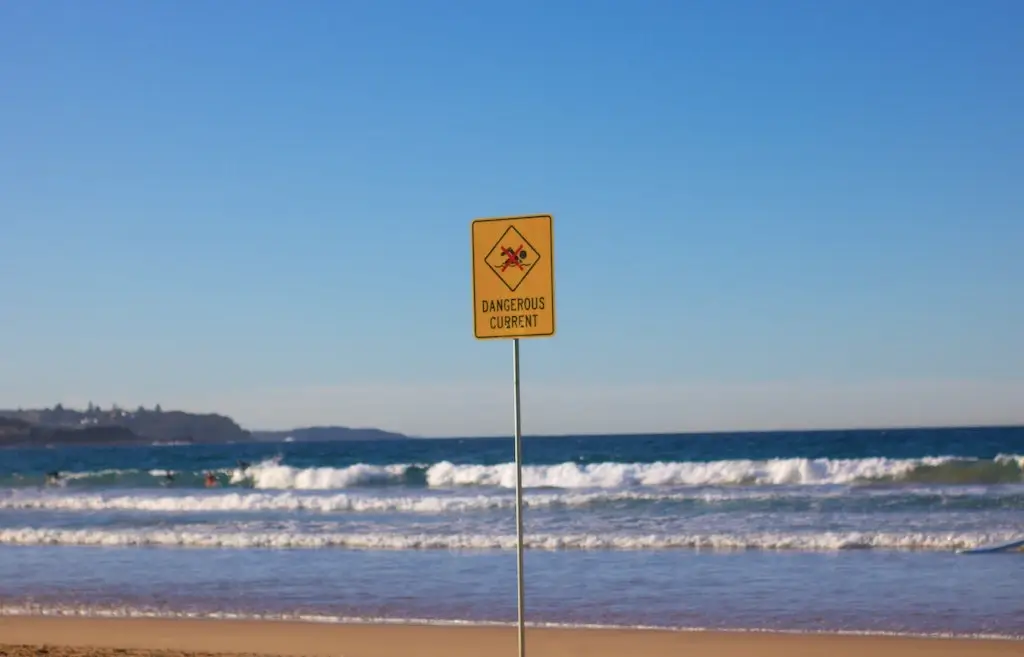 A sign saying Dangerous Current on a beach in Australia.