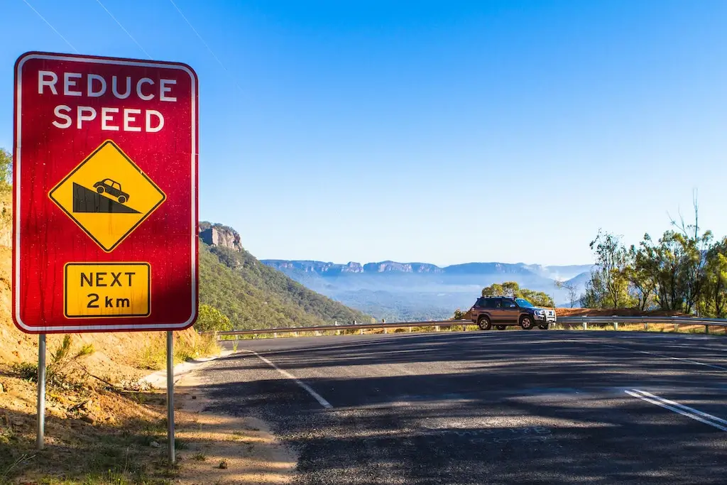 A roadsign in Australia telling drivers to reduce speed.