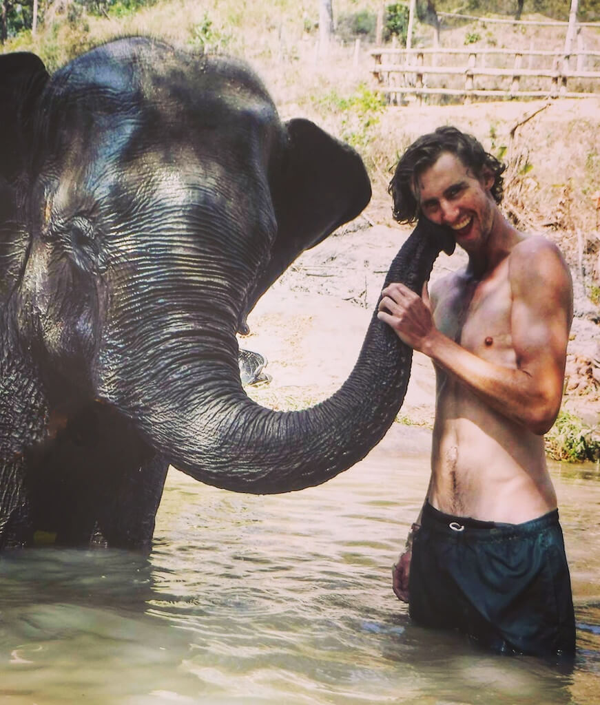 Harry (founder of Nomadic Yak) and an elephant in Thailand.