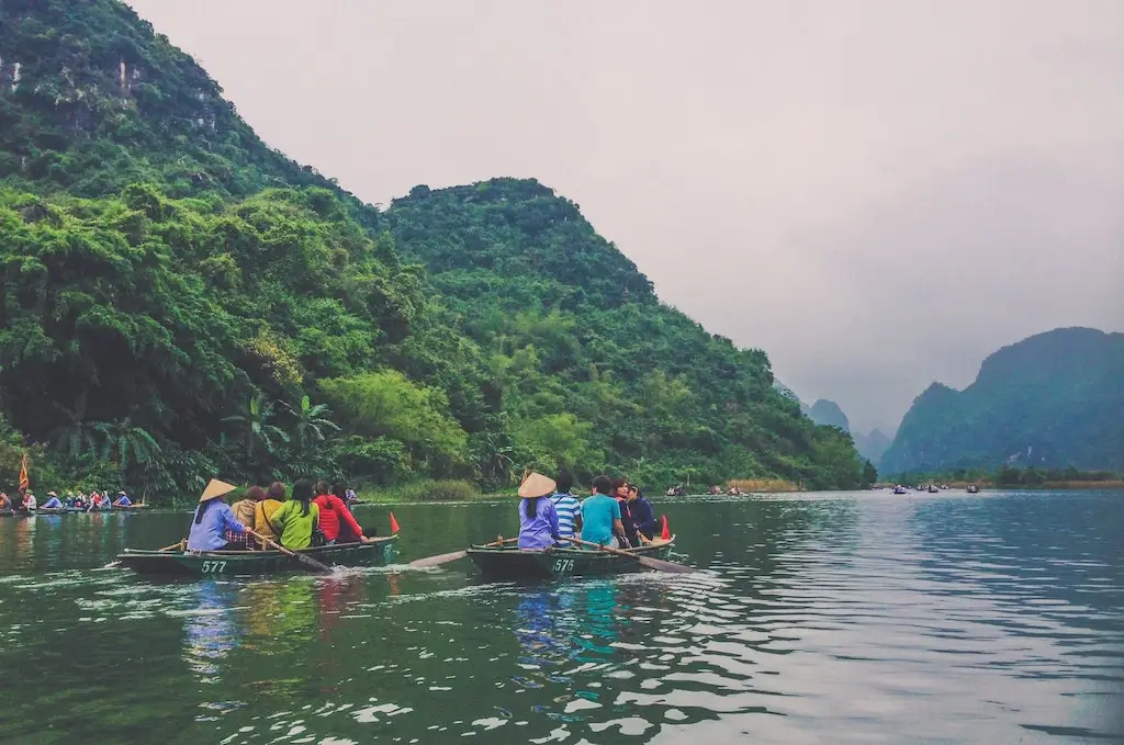 Tour group paddling down river in Vietnam.