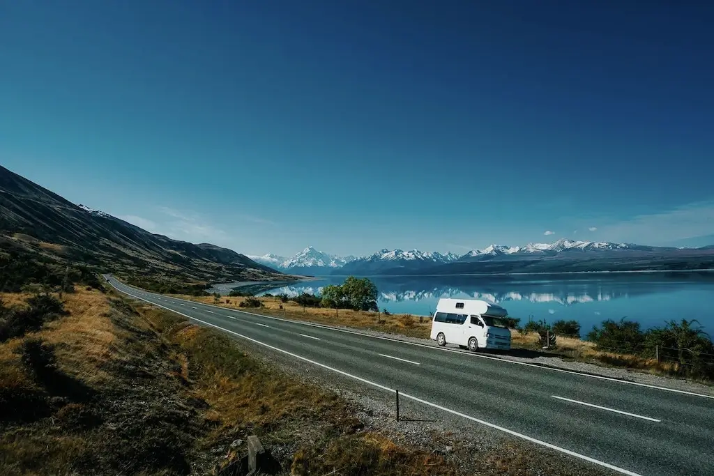 A campervan parked on the side of the road near Lake Pukaki in New Zealand.