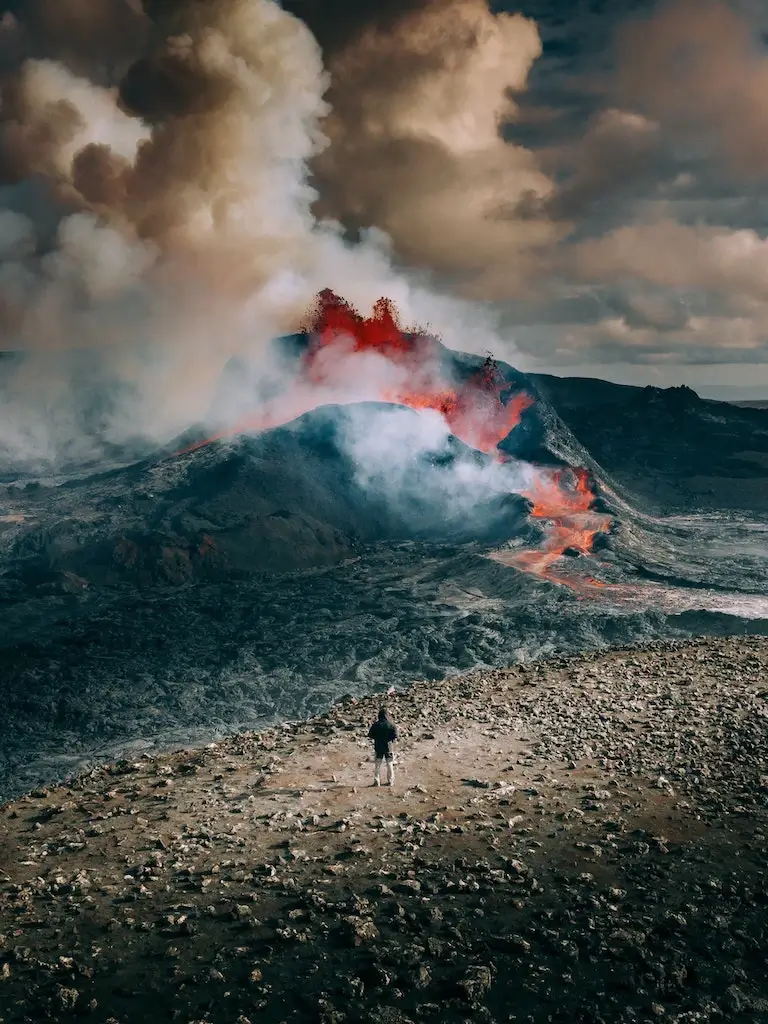 A solo traveller hiking an erupting volcano in Iceland