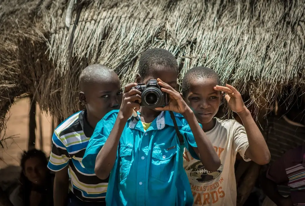 African children holding a digital camera