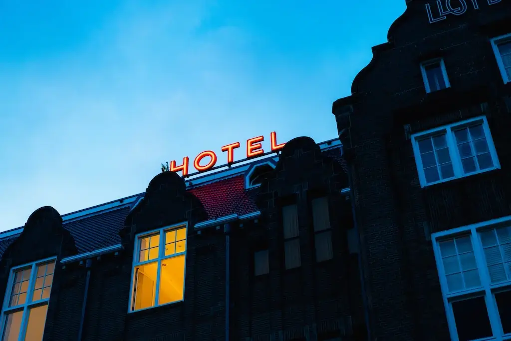 A glowing sign saying "Hotel" above a hotel