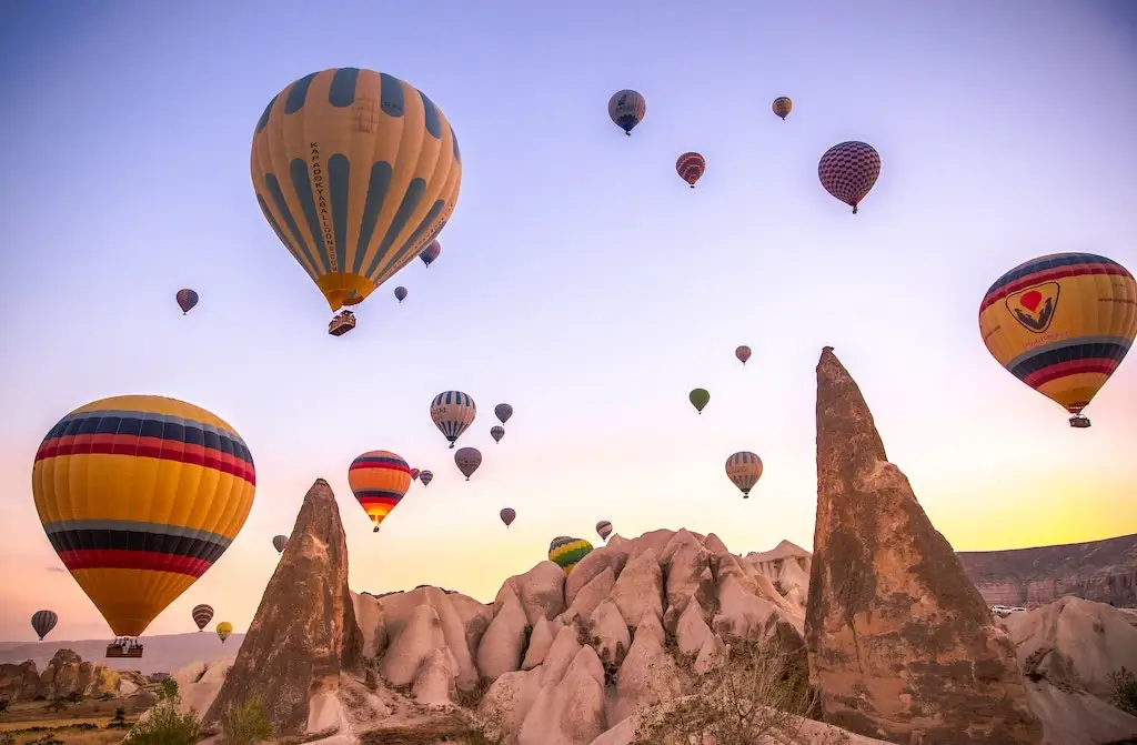 Hot air balloons flying at sunrise over Cappadocia in Turkey