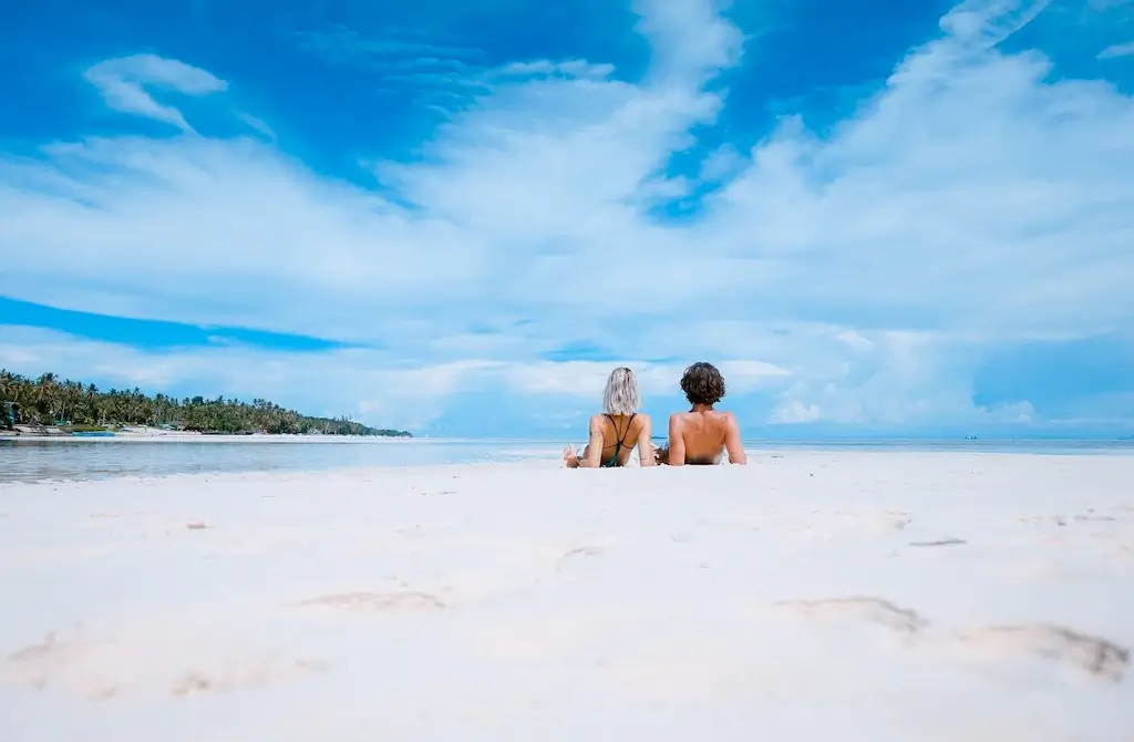A man and woman vacationing on a beach. 
