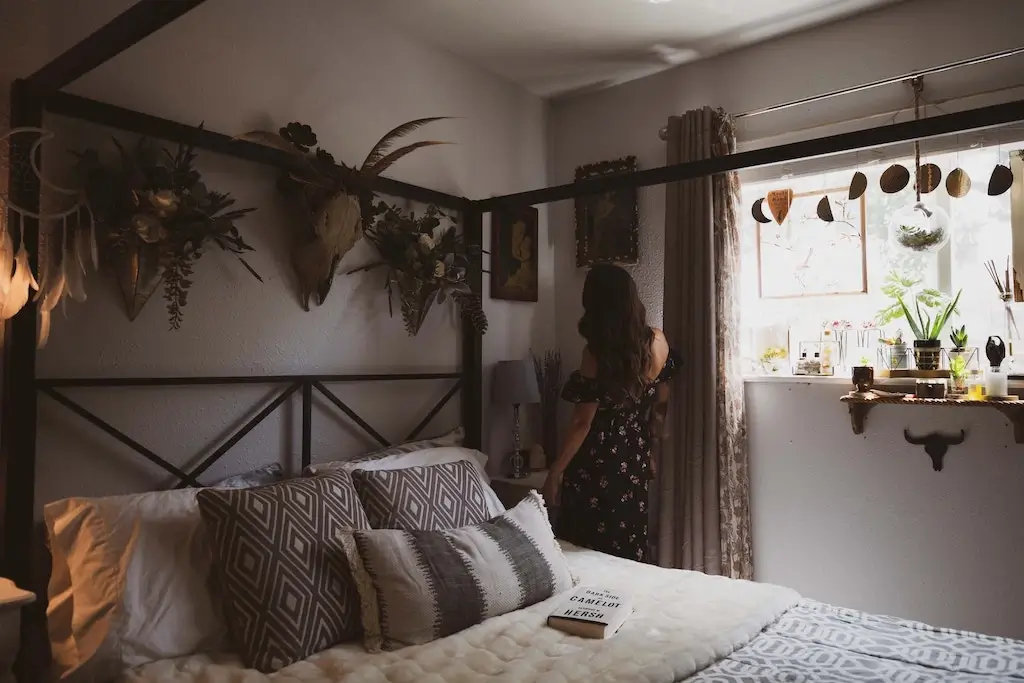 Woman decorating her cosy bedroom.