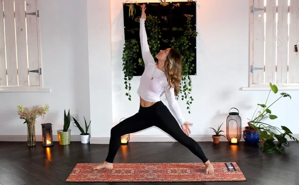 Woman doing a yoga pose in her home studio.