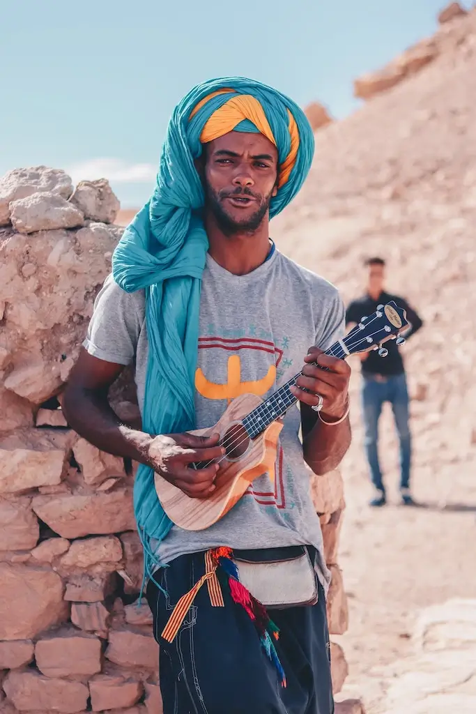 Moroccan Berber plays a travel-size guitar