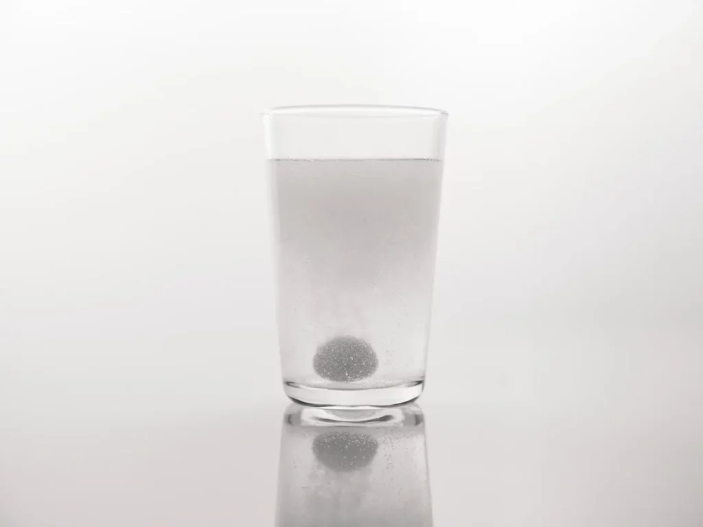 Pill dissolving in a glass of water.