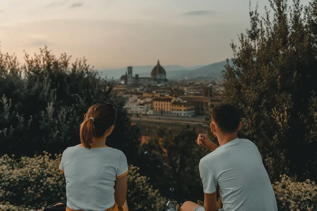 Tourist friends talking overlooking Italy.