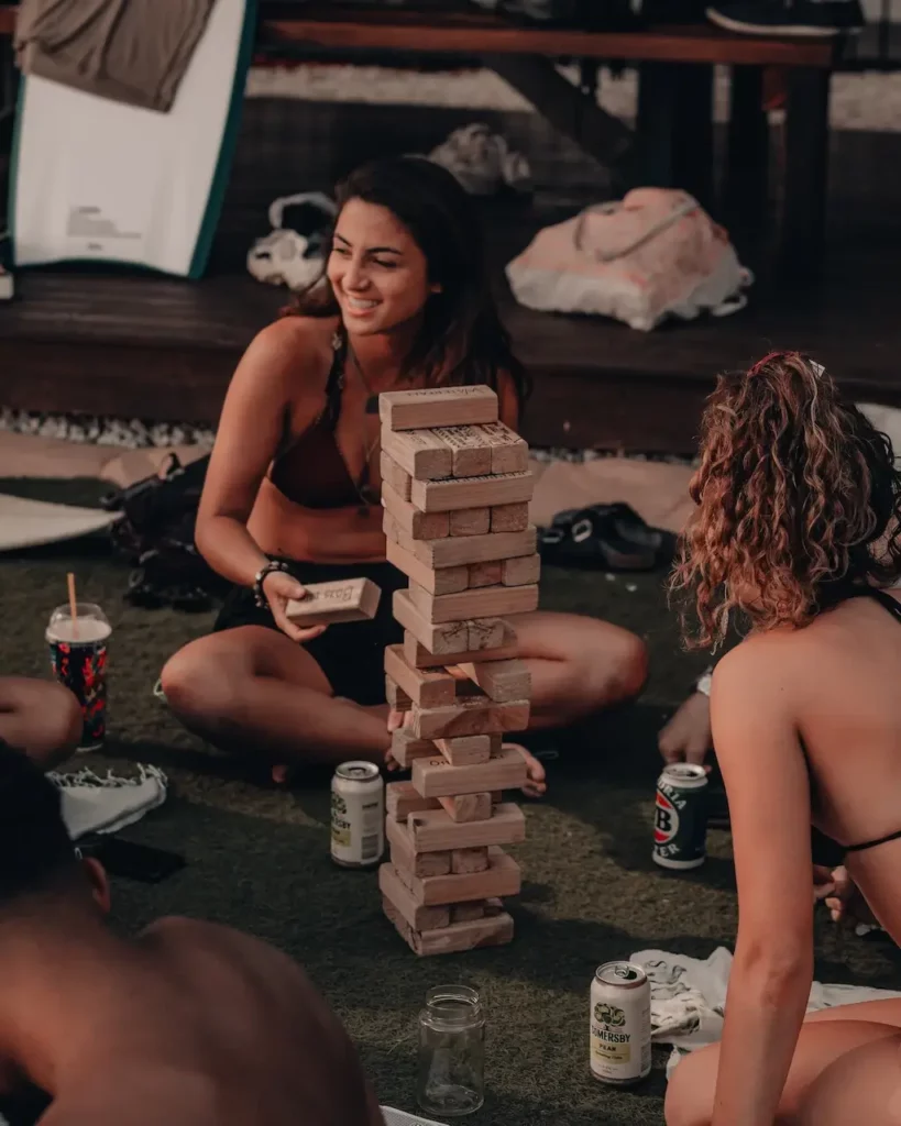 Travelling friends playing Jenga in a hostel common area in Australia