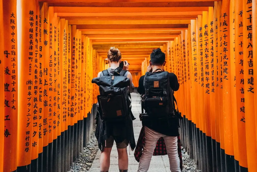 Two male travellers take photos in Japan