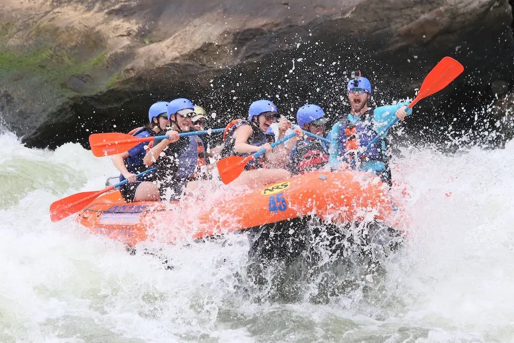 Group of tourists white water rafting.