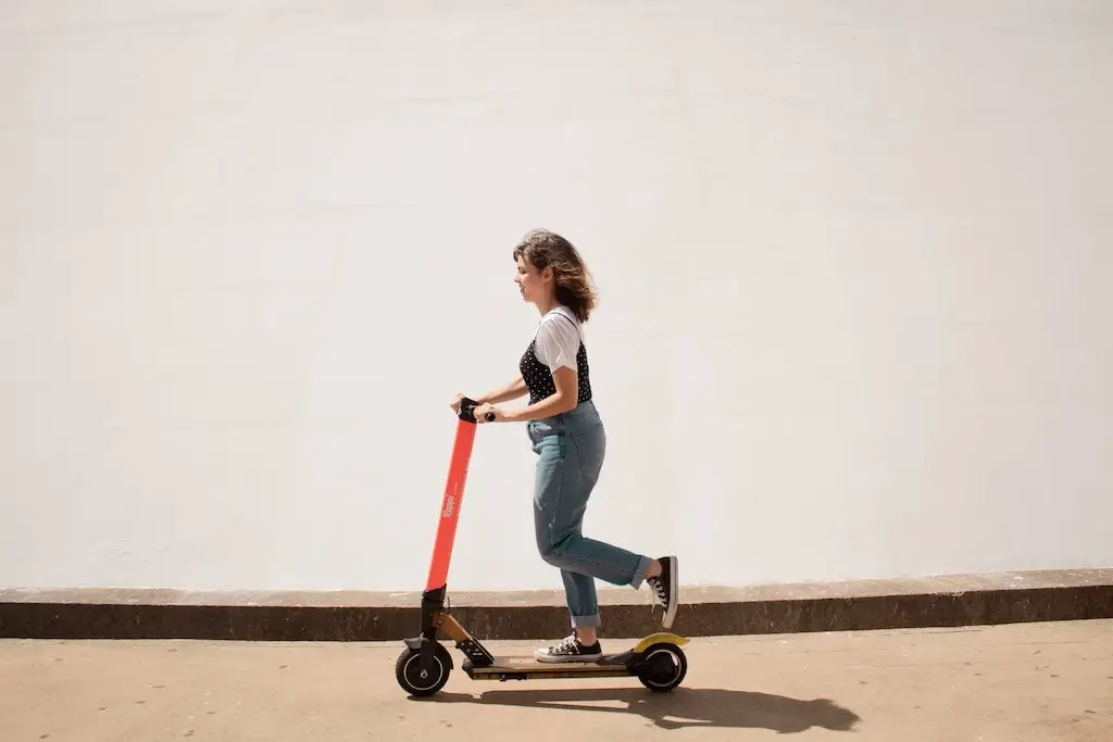 Woman riding an electric scooter.