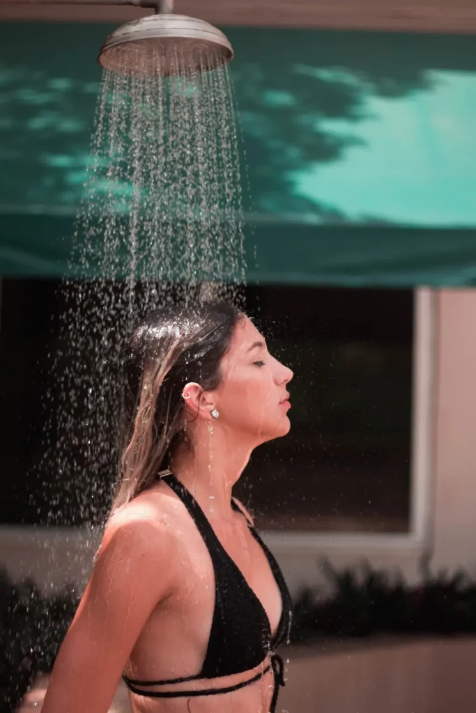 Woman showering outdoor in a bikini in Brazil.