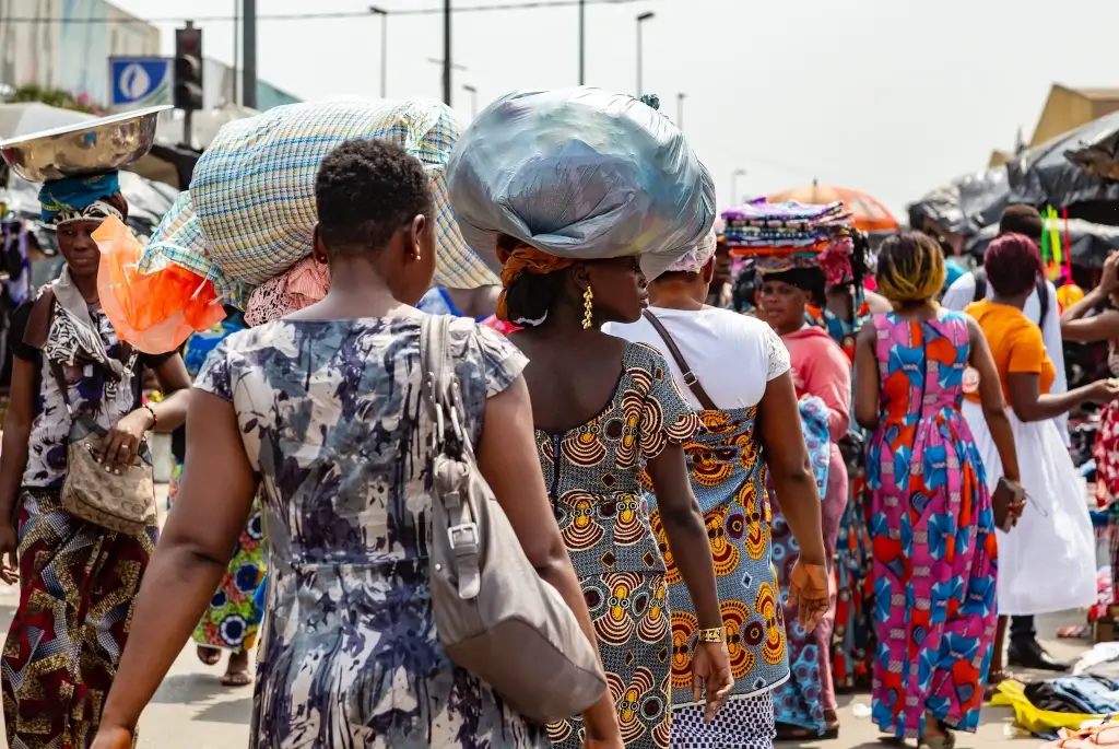 Women carrying goods in Adjame Market, Ivory Coast. 