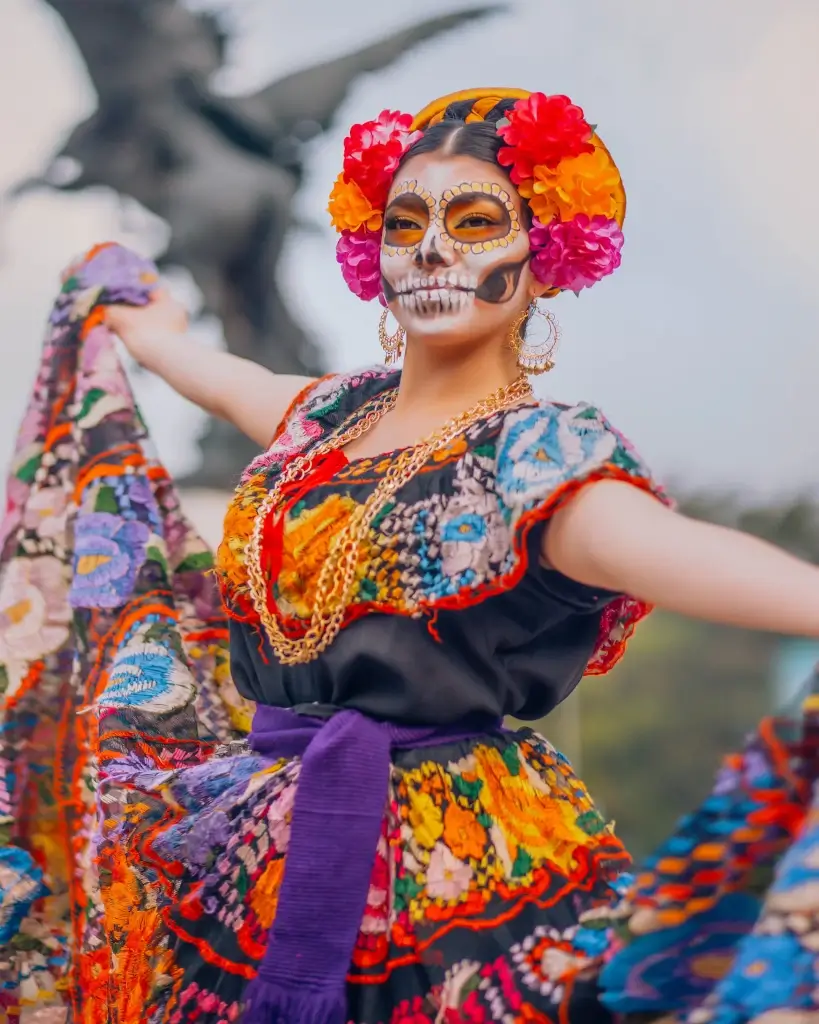 Local woman dressed in a huipil and face paint during the Day of the Dead in Mexico. 