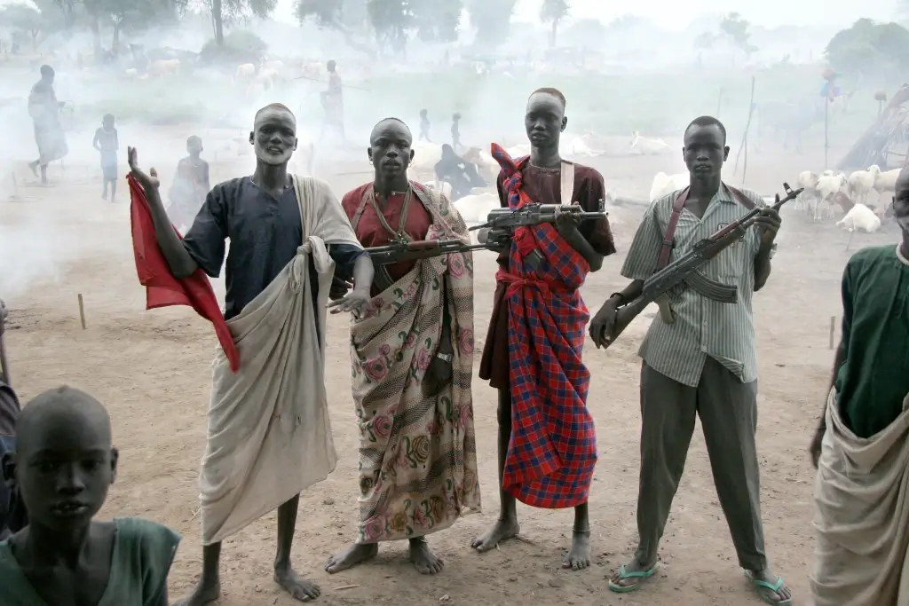 Dinka tribesmen posing with rifles in South Sudan. 