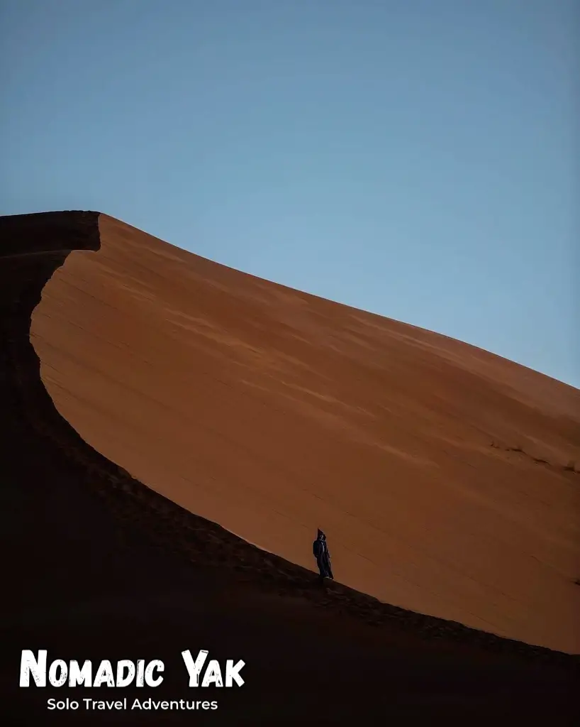 Harry Dale (Nomadic Yak) descending a sand dune in the Sahara Desert, Morocco. 