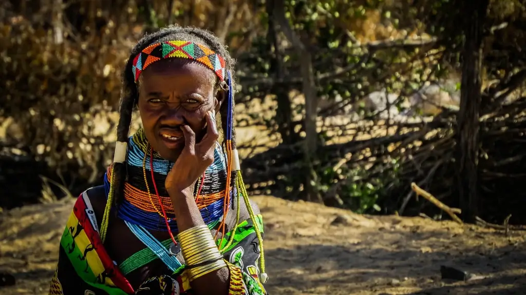 Mumuila tribal woman dressed in bright colourful clothing in Angola. 