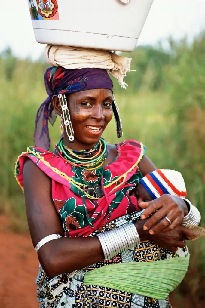 Tribal woman carrying a baby in Benin. 