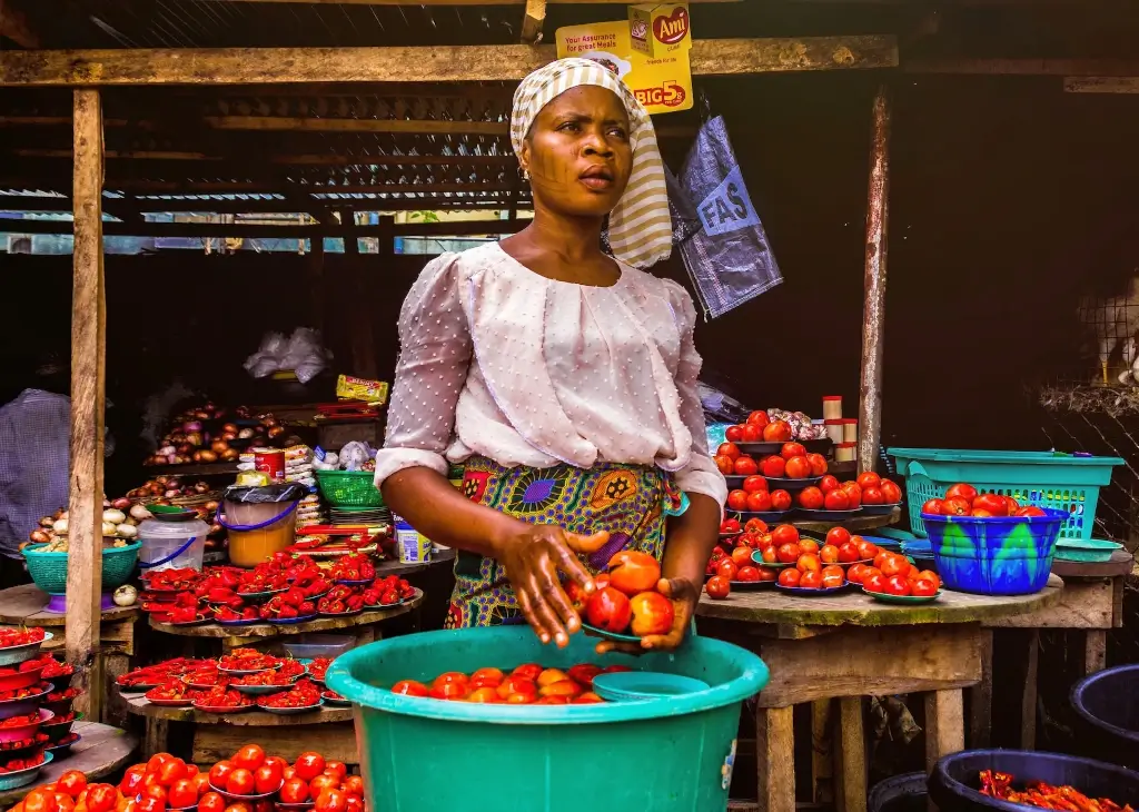 Woman selling peppers at market in Lagos, Nigeria. 